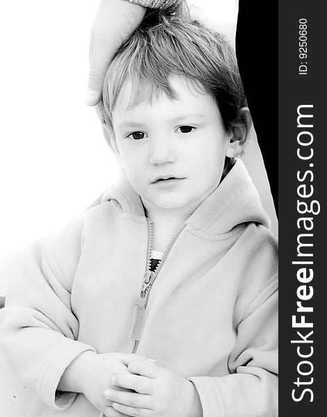 Boy's portrait with father's hand on his head over white