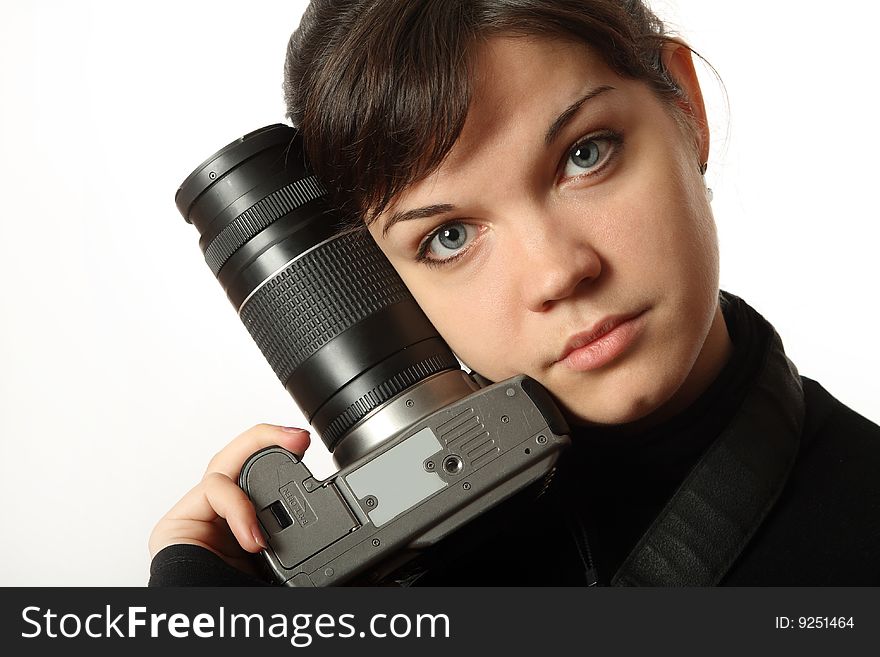 The beautiful girl with a camera on a white background