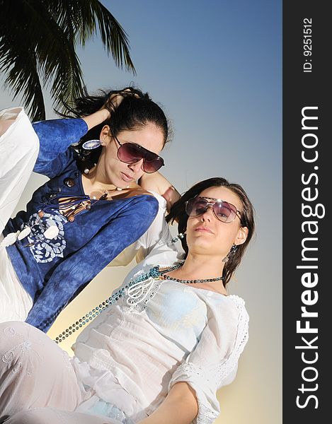 Portrait of two fashion female models on tropical beach. Portrait of two fashion female models on tropical beach