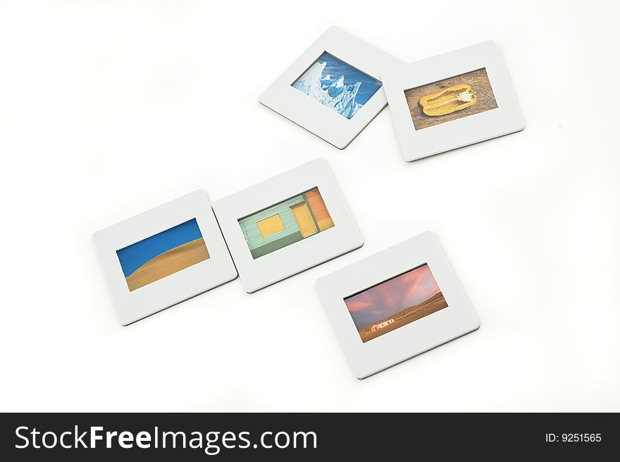 Five color slides with plastic frames on llightbox, close up. Five color slides with plastic frames on llightbox, close up.