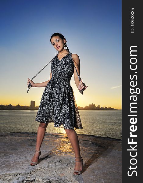 Portrait of young stylish female model posing at sunset. Portrait of young stylish female model posing at sunset