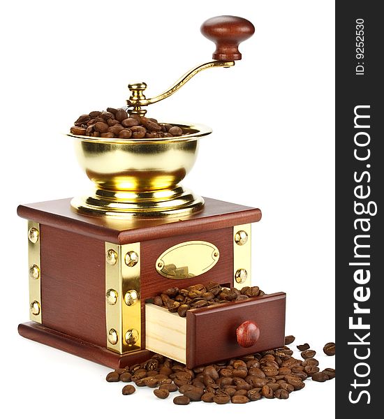 Old-fashioned coffee grinder and coffee beans on a white background. Old-fashioned coffee grinder and coffee beans on a white background