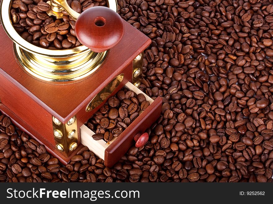 Background from old-fashioned coffee grinder and coffee beans. Background from old-fashioned coffee grinder and coffee beans
