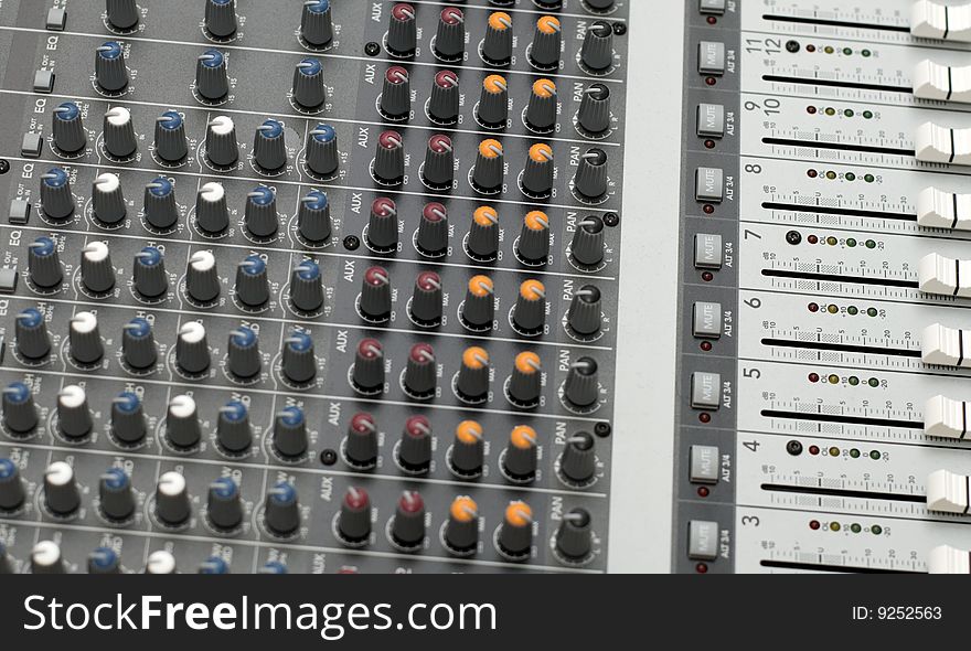 Knobs and sliders of a sound mixer