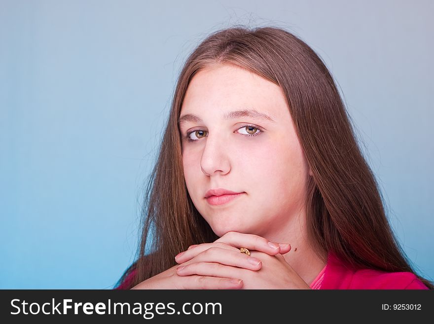 Teenage girl posing over blue background. Teenage girl posing over blue background