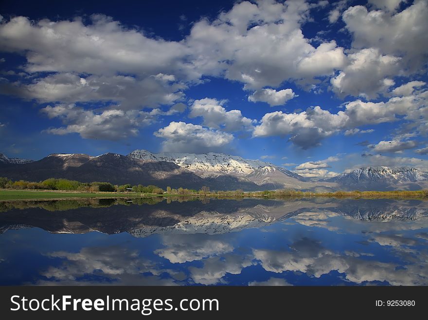 Rocky Mountains in the spring showing trees and snow capped mountains with
Refelections in a lake. Rocky Mountains in the spring showing trees and snow capped mountains with
Refelections in a lake