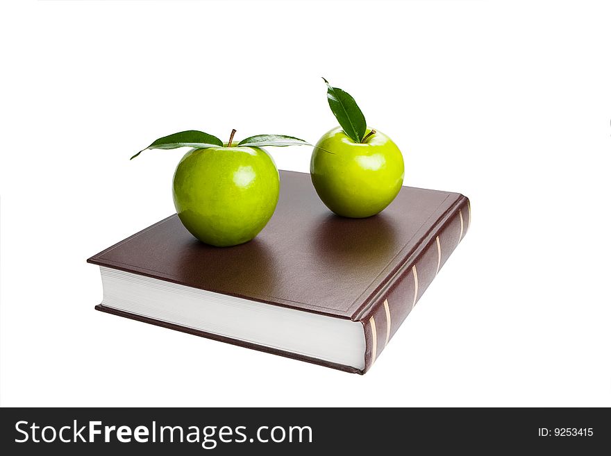 Book and green apples. White background