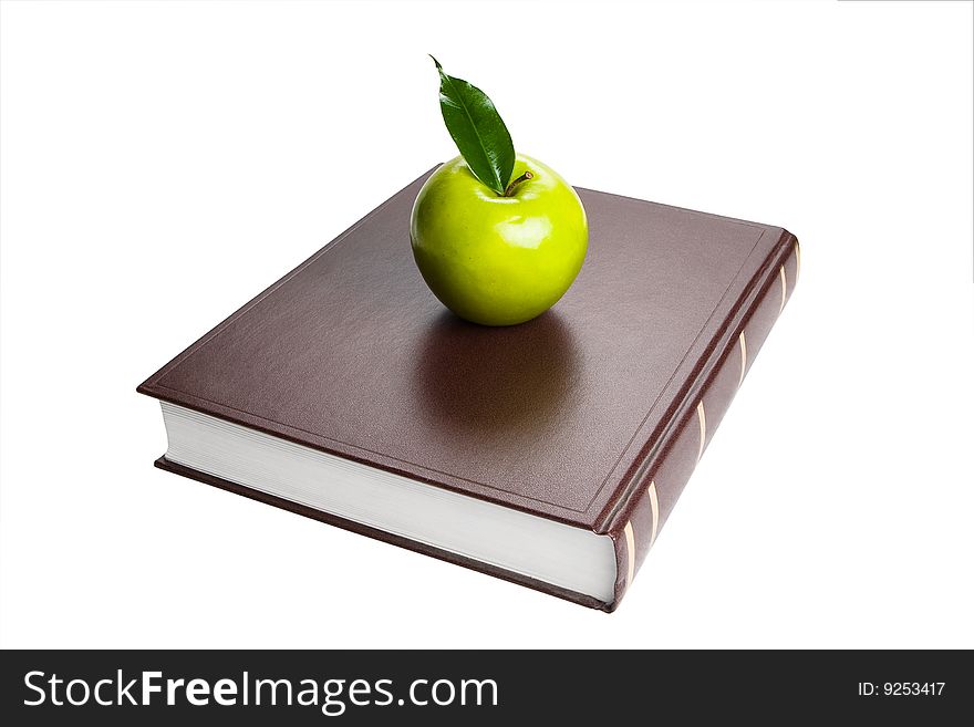Book and green apple. White background