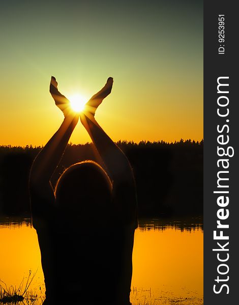 Silhouette woman with  sun in  hands. Silhouette woman with  sun in  hands