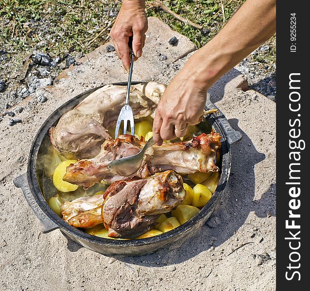 Preparing meat with potato for baking