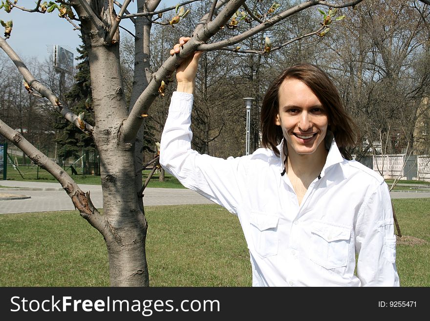 Happy Man Standing Near A Tree