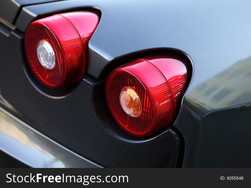 Red car lights on a gray car