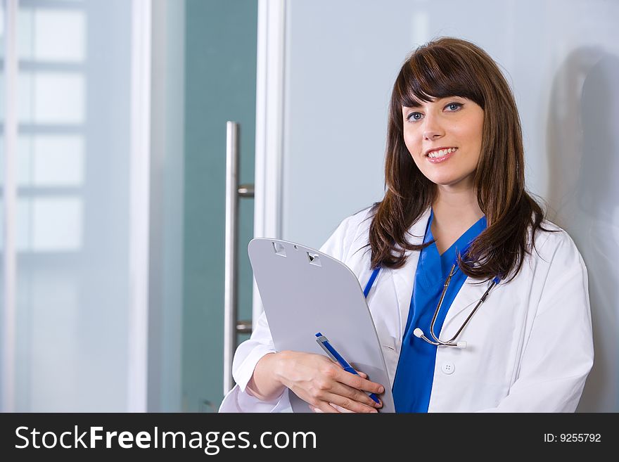 Woman doctor holding a chart in a modern office