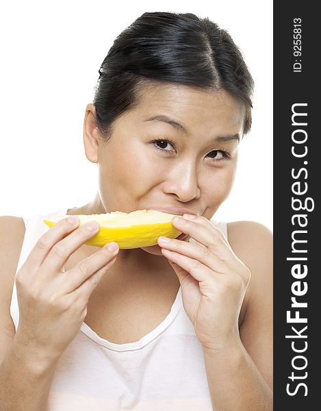 A young woman enjoys a slice of delicious melon. A young woman enjoys a slice of delicious melon