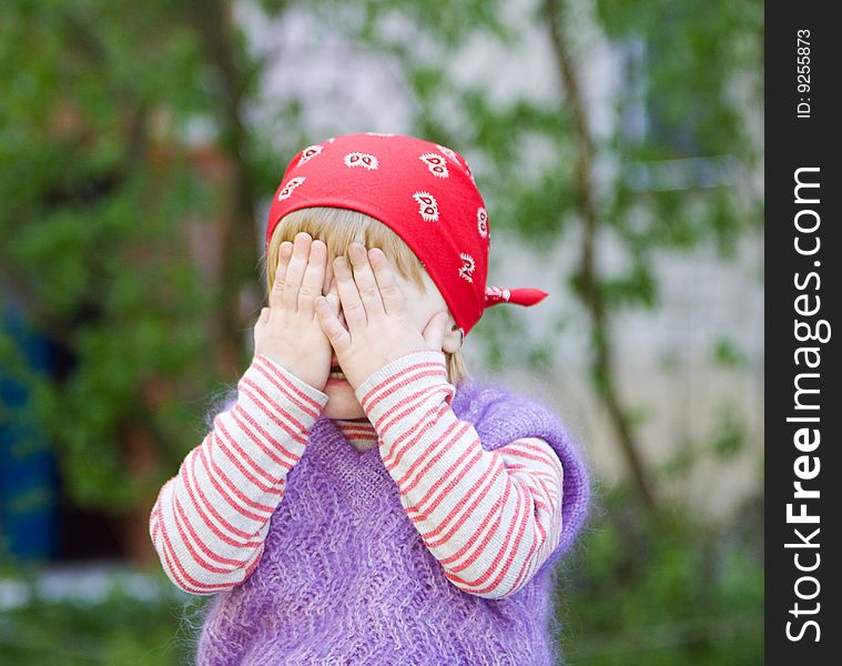 Young girl with her hands covering her eyes. Young girl with her hands covering her eyes.