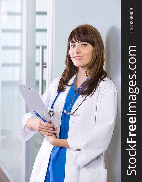 Woman doctor holding a chart in a modern office