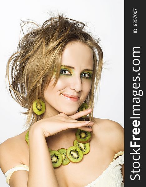 Portrait of young attractive woman with pieces of kiwi. Portrait of young attractive woman with pieces of kiwi