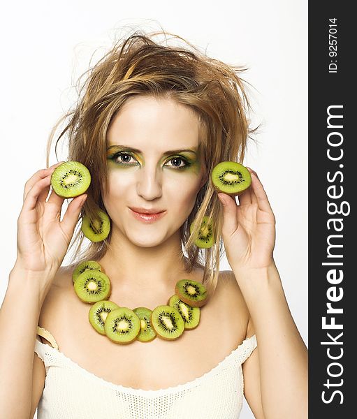 Portrait of young attractive woman with pieces of kiwi. Portrait of young attractive woman with pieces of kiwi