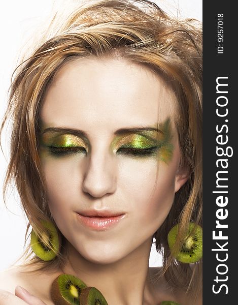 Portrait of young attractive woman with pieces of kiwi. Portrait of young attractive woman with pieces of kiwi