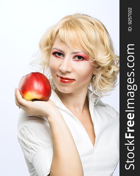 Portrait of young woman with red apple