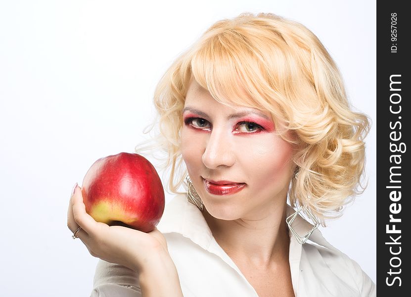 Portrait of young woman with red apple in her hand