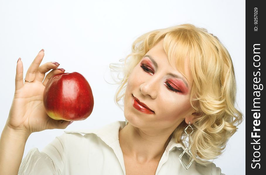 Portrait of young woman with red apple in her hand