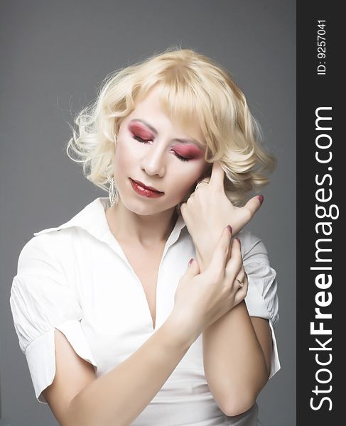 Portrait of woman with blond hair and bright make-up. Portrait of woman with blond hair and bright make-up