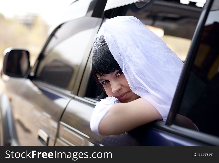 Pretty bride  in the car