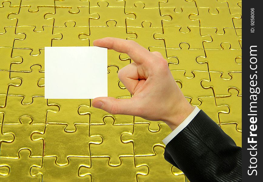 Blank card in hand isolated on gold background