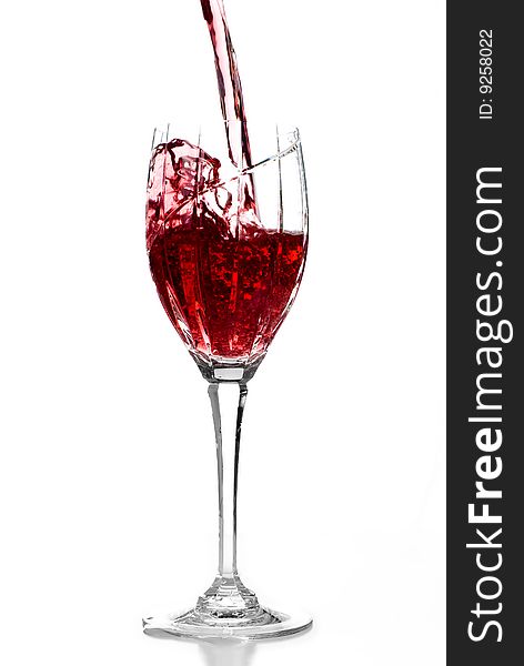 Pouring red wine into crystal glass. Pouring red wine into crystal glass