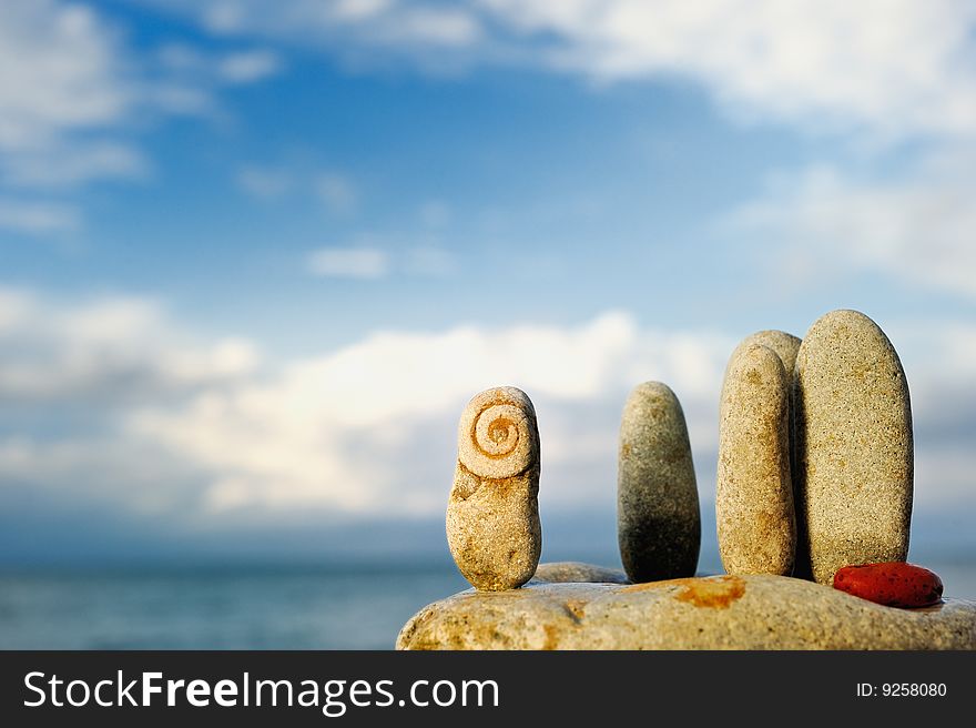 Oblong pebbles arranged vertically on the rock. Oblong pebbles arranged vertically on the rock