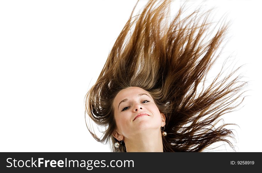 Fashion portrait of a young woman with hair lightly fluttering in the wind  on a white background. Fashion portrait of a young woman with hair lightly fluttering in the wind  on a white background