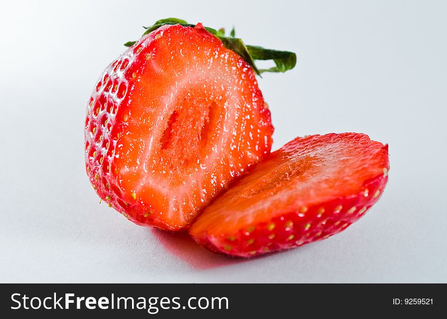 Juicy strawberry fruit split in two pieces. Juicy strawberry fruit split in two pieces