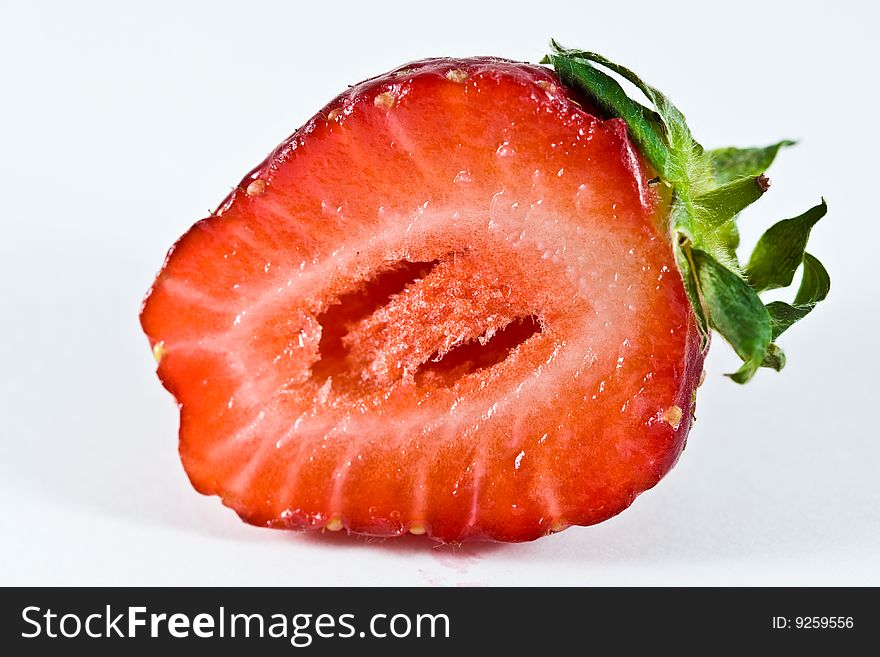 A single strawberry fruit isolated on a plain white background