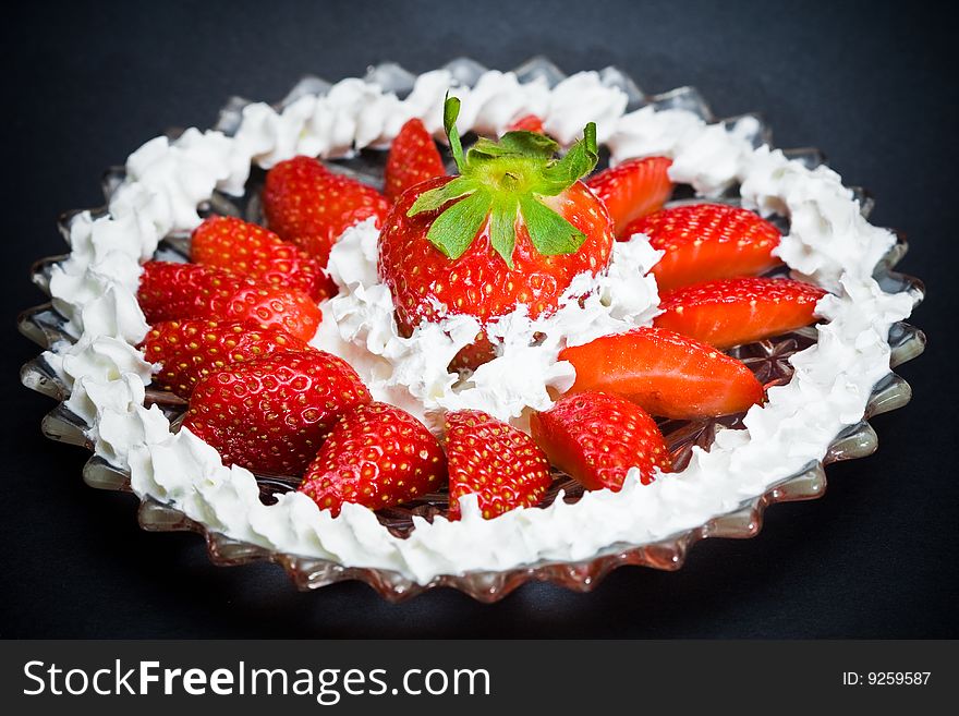 A plate full of strawberries and cream. A plate full of strawberries and cream