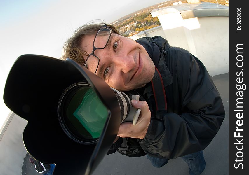 Happy photographer with a professional camera