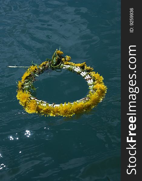 Wreath from dandelions floats on the wather. Wreath from dandelions floats on the wather