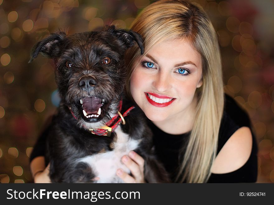 A woman holding a dog close to herself. A woman holding a dog close to herself.