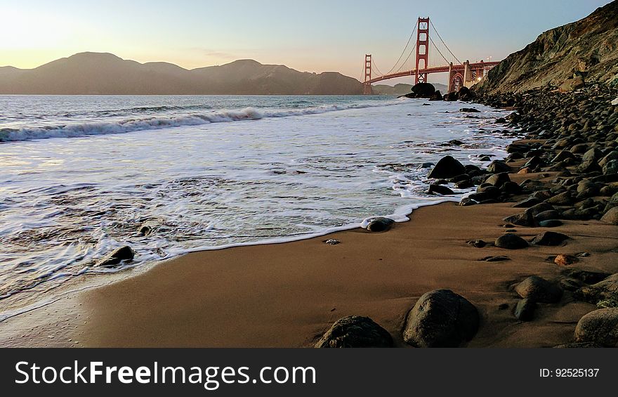 Waves breaking on beach with Golden Gate bridge in background, San Francisco, California, USA. Waves breaking on beach with Golden Gate bridge in background, San Francisco, California, USA.