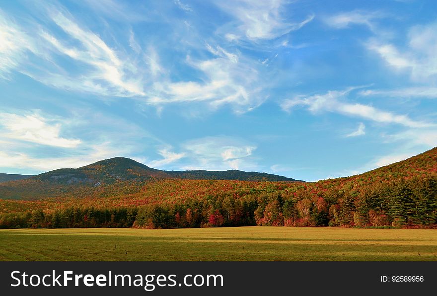 Autumn Foiliage Under Whispy Clouds At Grafton Notch, Maine, USA