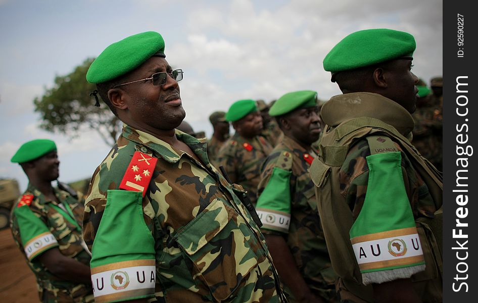 African Union Mission in Somalia &#x28;AMISOM&#x29; officers from Burundi and Uganda listen while AMISOM Force Commander Lt. Gen. Andrew Gutti &#x28;not seen&#x29; addresses Ugandan soldiers serving with the AU operation 5 June in Afgoye located 30km to the west of the Somali capital Mogadishu. AMISOM supporting Somali National Army &#x28;SNA&#x29; forces recently liberated the Afgoye Corridor from the Al Qaeda-affiliated extremist group Al Shabaab, pushing them further away from Mogadishu and opening up the free flow of goods and produce between the fertile agricultural area surrounding Afgoye and the Somali capital. AU-UN IST PHOTO / STUART PRICE. African Union Mission in Somalia &#x28;AMISOM&#x29; officers from Burundi and Uganda listen while AMISOM Force Commander Lt. Gen. Andrew Gutti &#x28;not seen&#x29; addresses Ugandan soldiers serving with the AU operation 5 June in Afgoye located 30km to the west of the Somali capital Mogadishu. AMISOM supporting Somali National Army &#x28;SNA&#x29; forces recently liberated the Afgoye Corridor from the Al Qaeda-affiliated extremist group Al Shabaab, pushing them further away from Mogadishu and opening up the free flow of goods and produce between the fertile agricultural area surrounding Afgoye and the Somali capital. AU-UN IST PHOTO / STUART PRICE.