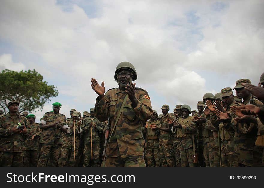 A Ugandan soldier serving with the African Union Mission in Somalia &#x28;AMISOM&#x29; sings a patriotic song 5 June during a visit by AMISOM Force Commander Lt. Gen. Andrew Gutti &#x28;not seen&#x29; to Ugandan soldiers serving with the AU operation 5 June in Afgoye located 30km to the west of the Somali capital Mogadishu. AMISOM supporting Somali National Army &#x28;SNA&#x29; forces recently liberated the Afgoye Corridor from the Al Qaeda-affiliated extremist group Al Shabaab, pushing them further away from Mogadishu and opening up the free flow of goods and produce between the fertile agricultural area surrounding Afgoye and the Somali capital. AU-UN IST PHOTO / STUART PRICE. A Ugandan soldier serving with the African Union Mission in Somalia &#x28;AMISOM&#x29; sings a patriotic song 5 June during a visit by AMISOM Force Commander Lt. Gen. Andrew Gutti &#x28;not seen&#x29; to Ugandan soldiers serving with the AU operation 5 June in Afgoye located 30km to the west of the Somali capital Mogadishu. AMISOM supporting Somali National Army &#x28;SNA&#x29; forces recently liberated the Afgoye Corridor from the Al Qaeda-affiliated extremist group Al Shabaab, pushing them further away from Mogadishu and opening up the free flow of goods and produce between the fertile agricultural area surrounding Afgoye and the Somali capital. AU-UN IST PHOTO / STUART PRICE.
