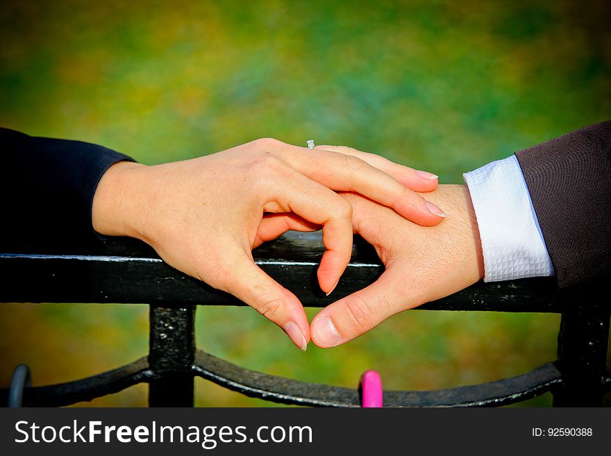 Couple Making A Heart Shape With Their Hands