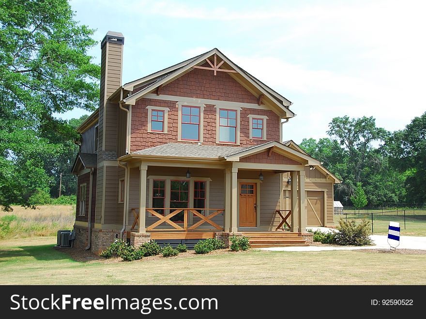 A two storey house with a big yard.