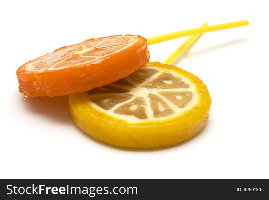 Sugar candies on  stick in the form of fruit on  white background. Sugar candies on  stick in the form of fruit on  white background