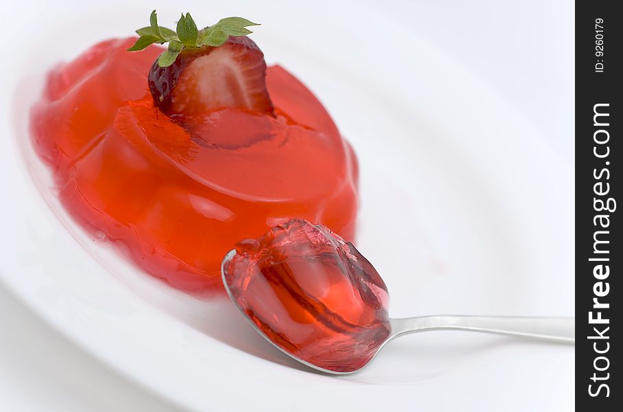 Strawberry dessert, half  berry and spoon on  white plate. Strawberry dessert, half  berry and spoon on  white plate