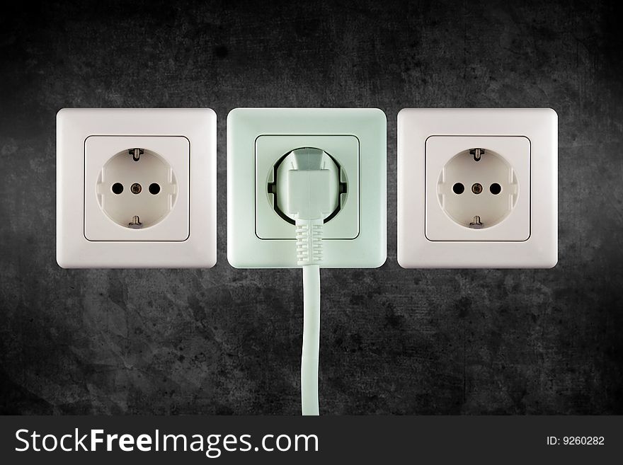 Three little sockets of electricity in a wall