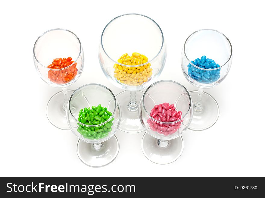 Transparent glasses with colour sweetmeat insulated on white background