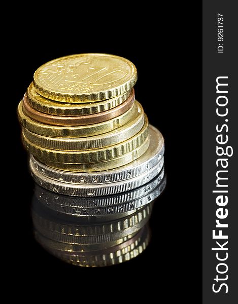 Stack of coins on black isolated