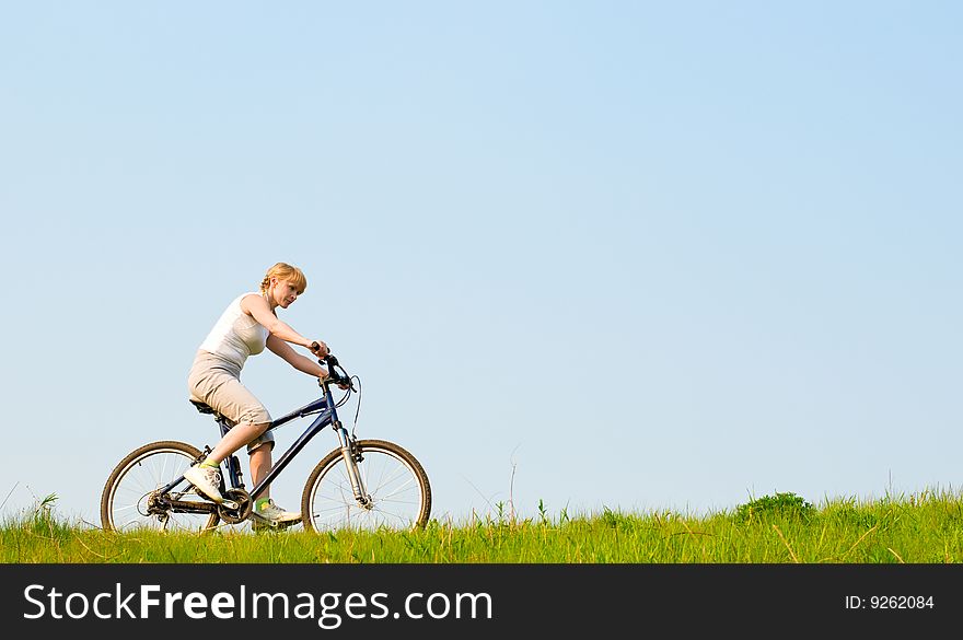 Girl relax biking on green grass